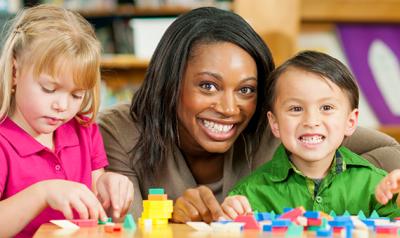 Teacher in the classroom with young children.